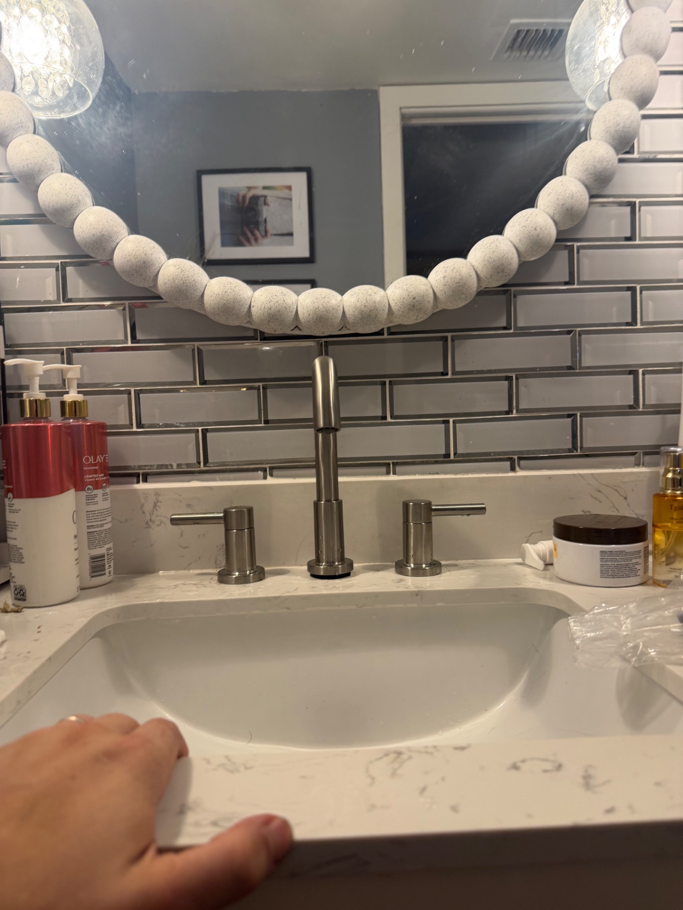 Modern brushed-nickel widespread bathroom faucet installed on a quartz vanity by Better Call Sam Plumbing