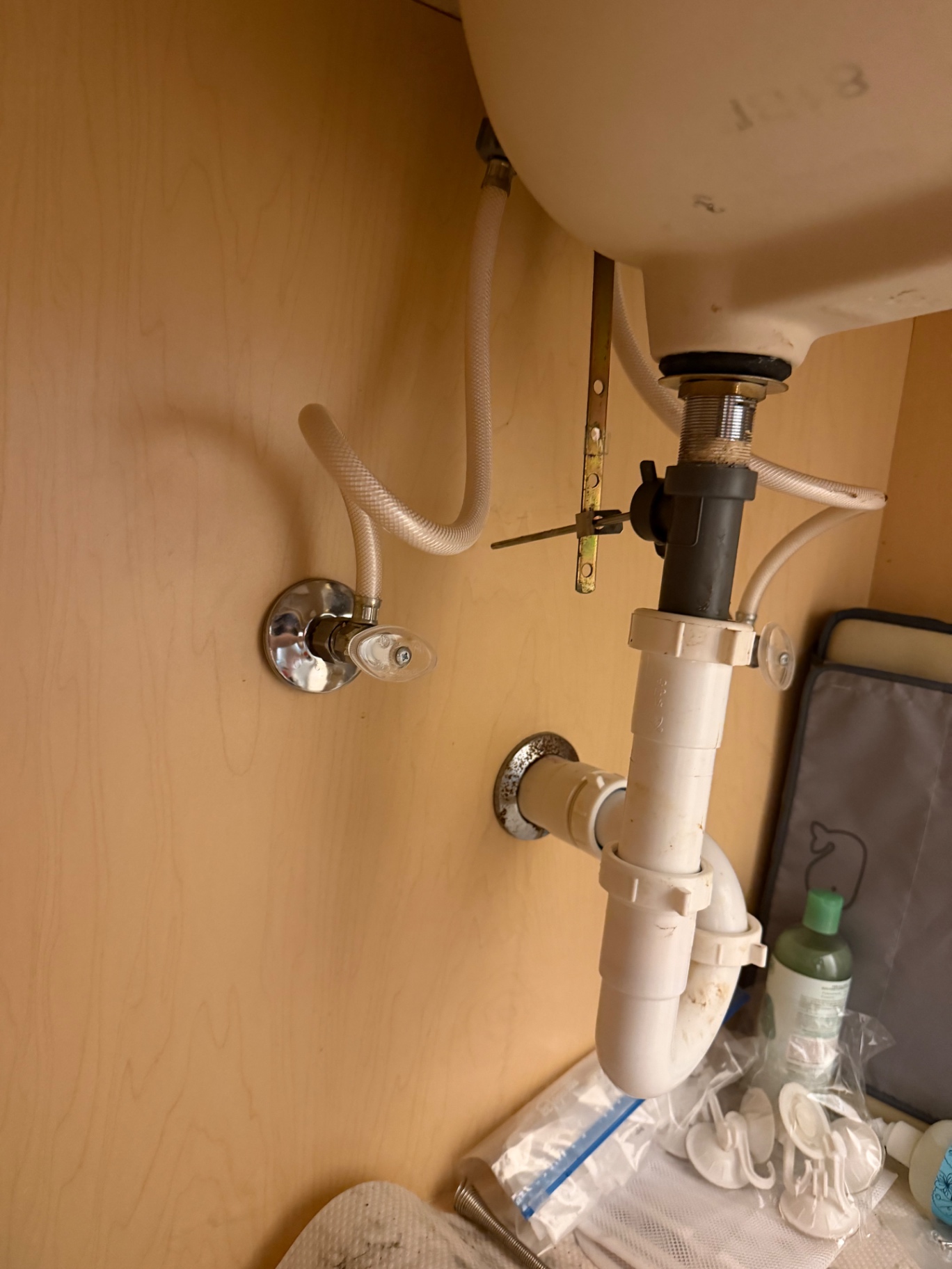 New chrome angle stop and PVC P-trap serviced beneath a pedestal bathroom sink by BCS Plumbing